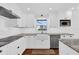 Modern, updated kitchen featuring stainless steel appliances, white cabinets, and granite countertops at 128 W Juliana Way, Auburndale, FL 33823