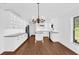 Spacious, open kitchen featuring white cabinets, granite countertops, and stainless steel appliances at 128 W Juliana Way, Auburndale, FL 33823