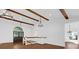 Open living room featuring wood beams, high ceilings, modern lighting, and staircase at 128 W Juliana Way, Auburndale, FL 33823