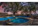 The screened pool and spa area with a peaceful lake view, perfect for relaxation and enjoyment at 128 W Juliana Way, Auburndale, FL 33823