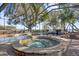 Covered pool area with hot tub, waterfall, and lake views, great for relaxing and entertaining at 128 W Juliana Way, Auburndale, FL 33823