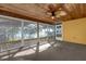 Spacious sunroom with wood ceiling, carpet flooring, and large windows offering scenic views at 128 W Juliana Way, Auburndale, FL 33823