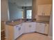 Kitchen boasts granite countertops and white cabinetry at 13620 Waterhouse Way, Orlando, FL 32828