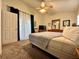 Bright bedroom featuring a queen bed, dresser, and access to a balcony with natural light streaming in at 2555 Oneida Loop, Kissimmee, FL 34747