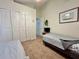 Neutral bedroom featuring twin beds, plush carpet, and ample closet space, illuminated by a ceiling fan at 2555 Oneida Loop, Kissimmee, FL 34747