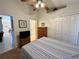 Comfortable bedroom with a queen bed, ceiling fan, dresser, and closet, leading to an en-suite bathroom at 2555 Oneida Loop, Kissimmee, FL 34747