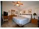 Spacious bedroom features a queen bed, ceiling fan, dresser, and rocking chair, creating a relaxing retreat at 2555 Oneida Loop, Kissimmee, FL 34747