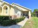 Charming home featuring a well-maintained lawn, brick accents, and an inviting front porch with comfortable seating at 2555 Oneida Loop, Kissimmee, FL 34747