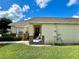 Inviting front porch with chairs, showcasing the home's exterior with well-maintained landscaping and a cozy entrance at 2555 Oneida Loop, Kissimmee, FL 34747