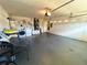 Spacious garage with gray painted floor, with laundry area, workbench and garage door at 2555 Oneida Loop, Kissimmee, FL 34747