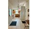 Open kitchen features wooden cabinets, tiled floor, and ample natural light for a welcoming cooking space at 2555 Oneida Loop, Kissimmee, FL 34747