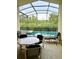 Enclosed lanai featuring pool, spa, and outdoor seating at 2555 Oneida Loop, Kissimmee, FL 34747