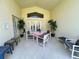 Covered lanai featuring outdoor seating and dining area at 2555 Oneida Loop, Kissimmee, FL 34747