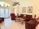 Cozy living room with comfortable seating, tiled floors, and natural light creating a relaxing space at 2555 Oneida Loop, Kissimmee, FL 34747