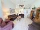 Inviting living room with neutral tile flooring, high ceilings, ceiling fan, and comfortable seating arrangement at 2555 Oneida Loop, Kissimmee, FL 34747