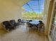 Enclosed patio with an outdoor dining area, perfect for entertaining near the backyard pool at 2555 Oneida Loop, Kissimmee, FL 34747