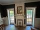 Charming fireplace with tiled hearth, flanked by French doors leading outdoors at 5021 Harbor Hts, Lady Lake, FL 32159