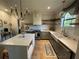 Modern kitchen featuring white cabinets, a center island, and a farmhouse sink at 5021 Harbor Hts, Lady Lake, FL 32159