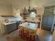 Modern kitchen with white island, gray cabinets, and a chandelier at 5021 Harbor Hts, Lady Lake, FL 32159