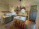 Modern kitchen with white island, gray cabinets, and a chandelier at 5021 Harbor Hts, Lady Lake, FL 32159