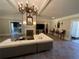 Spacious living room featuring a large sectional sofa and ornate chandelier at 5021 Harbor Hts, Lady Lake, FL 32159