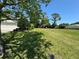 Large grassy lot with mature trees and partial view of neighboring homes at 5021 Harbor Hts, Lady Lake, FL 32159