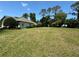 Large vacant lot with a home partially visible in the background at 5021 Harbor Hts, Lady Lake, FL 32159