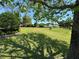 Spacious homesite with lush lawn and mature trees providing shade at 5021 Harbor Hts, Lady Lake, FL 32159