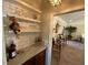 Well-stocked wet bar with marble countertop and glass shelving at 5021 Harbor Hts, Lady Lake, FL 32159