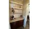 Well-stocked wet bar with marble countertop and glass shelving at 5021 Harbor Hts, Lady Lake, FL 32159