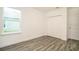 Bedroom with wood-look tile floor and double closet at 2223 Elegant Manor Cir, Edgewater, FL 32141