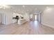 Bright and airy open living space with a kitchen island and wood-look tile flooring at 2235 Elegant Manor Cir, Edgewater, FL 32141