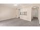 Bright living room featuring smooth walls with an arched doorway and large windows at 911 N Orange Ave # 408, Orlando, FL 32801