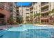 Outdoor community pool surrounded by lush greenery and multiple condominiums at 911 N Orange Ave # 408, Orlando, FL 32801