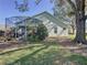 Backyard with screened patio, lush landscaping, and large tree at 3507 Tenby Cir, Clermont, FL 34711