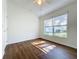 Well-lit bedroom with wood-look floors and window blinds at 3507 Tenby Cir, Clermont, FL 34711