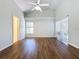Bright bedroom featuring wood-look floors, ceiling fan and sliding door access to patio at 3507 Tenby Cir, Clermont, FL 34711