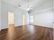 Spacious bedroom with wood-look floors, ceiling fan, and access to bathroom and closet at 3507 Tenby Cir, Clermont, FL 34711