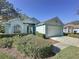 House exterior showcasing a two-car garage and well-manicured landscaping at 3507 Tenby Cir, Clermont, FL 34711