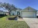 House exterior showcasing a two-car garage and well-manicured landscaping at 3507 Tenby Cir, Clermont, FL 34711