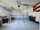 Garage interior with ample storage space and overhead door at 3507 Tenby Cir, Clermont, FL 34711