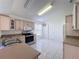 Kitchen boasts light wood cabinets, tile floors, and stainless steel appliances at 3507 Tenby Cir, Clermont, FL 34711