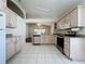 Kitchen with light wood cabinets, tile floor, and stainless steel appliances at 3507 Tenby Cir, Clermont, FL 34711