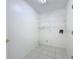 Laundry room with wire shelving and tile flooring at 3507 Tenby Cir, Clermont, FL 34711
