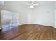 Open living area with wood-look floors, ceiling fan and sliding glass doors at 3507 Tenby Cir, Clermont, FL 34711