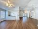 Spacious living room with kitchen view and wood-look floors at 3507 Tenby Cir, Clermont, FL 34711