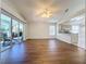 Living room with wood-like floors, view of kitchen, and access to patio at 3507 Tenby Cir, Clermont, FL 34711