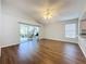 Living room with wood-like floors, view of kitchen, and access to patio at 3507 Tenby Cir, Clermont, FL 34711