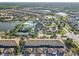 Aerial view of the community highlighting the pool, lake, tennis court, and residential area at 2054 Rome Dr, Kissimmee, FL 34747