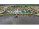 Aerial view of the community pool, recreation areas, lake, and surrounding homes at 2054 Rome Dr, Kissimmee, FL 34747